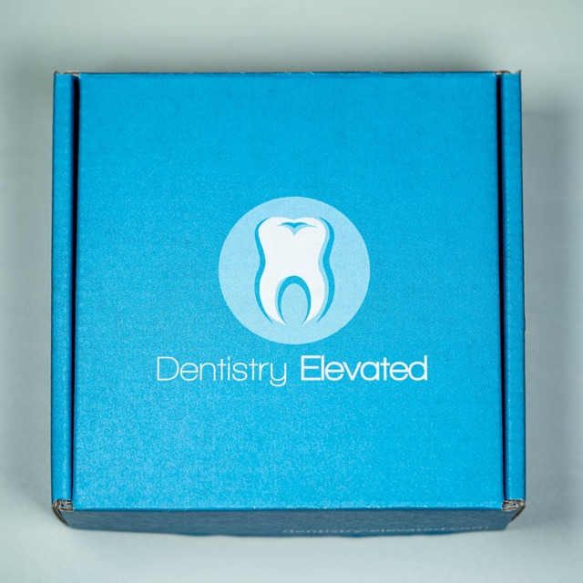 Blue product boxing the DentXpin comes in with the Dentistry Elevated logo on the front.
